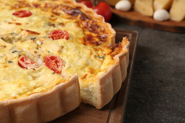 Delicious homemade cheese quiche on gray table, closeup