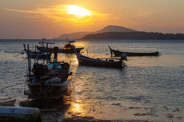 .amazing yellow sky of sunrise above the island. The sunlight reflects off the particles in the atmosphere, .creating a beautiful yellow glow that is further enhanced by the horizon of the island..