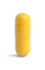 One yellow pill on white background. Medicinal treatment