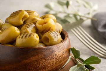 Grilled green olives on vintage background