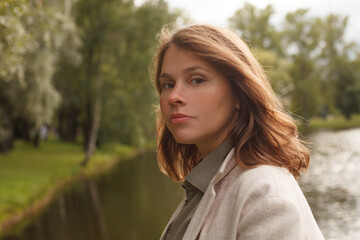 Fototapeta premium Young beautiful woman outdoor, female face closeup