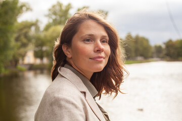 Beautiful carefree woman with brown hair outdoor, closeup portrait