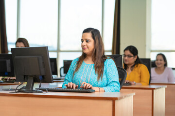 Indian woman working on computer at office.