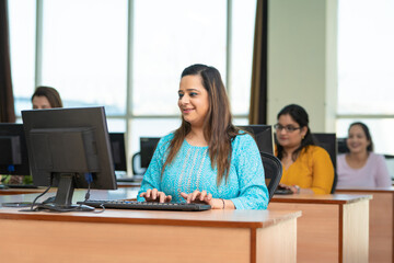 Indian woman working on computer at office.