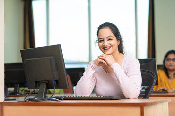 Indian woman working on computer at office.