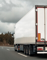 Cargo truck on the mountain highway. Delivery truck on the Europe motorway.