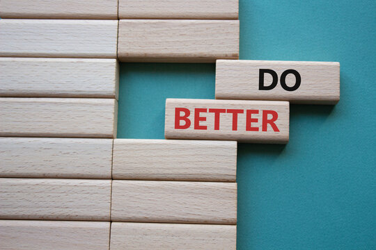 Do better symbol. Wooden blocks with words Do better. Beautiful grey green background. Business and Do better concept. Copy space.