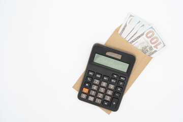 Dollars in paper envelopes with Calculator isolated on white background. Finance and profits concept.