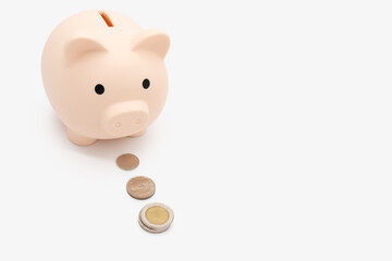 The Piggy Bank follows the coin to collect the money in isolated background. saving money wealth and financial concept, Business, finance, investment, Financial planning. Follow a plan to save money.