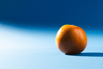 Close up of orange and copy space on blue background