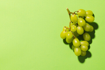 Close up of white grapes and copy space on green background