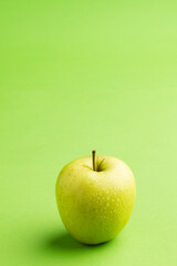 Close up of green apple and copy space on green background