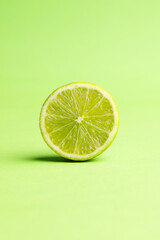 Close up of halved lime and copy space on green background