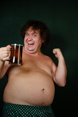 Funny fat shirtless man drinking beer.
