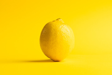 Close up of lemon and copy space on yellow background