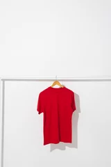 Foto op Plexiglas Red t shirt on hanger hanging from clothes rail with copy space on white background © vectorfusionart