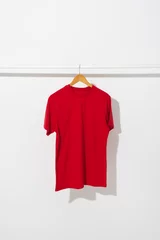 Keuken foto achterwand Red t shirt on hanger hanging from clothes rail with copy space on white background © vectorfusionart