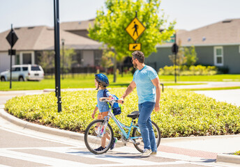 father and son on bicycle at fathers day. active father setting a example for fathers son. fathers parenting with son outdoor. childhood of son supported by fathers care. teaching moments