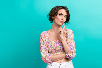 Photo of minded pretty lady pouted lips finger touch chin look empty space contemplate isolated on...