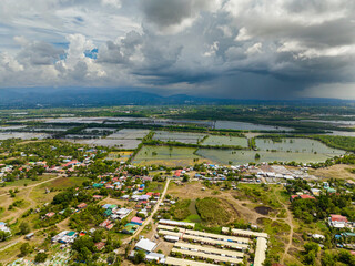 Aquaculture: Fish farm near the village in the Philippines. Blue sky and clouds. Mindanao.