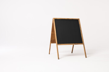 Black sign in wooden frame and copy space on white background