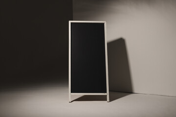 Black sign in white frame and copy space on grey background