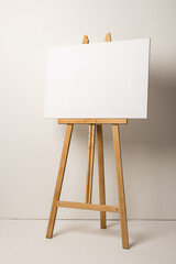 White canvas on wooden easel and copy space on white background