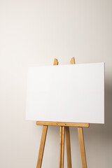 White canvas on wooden easel and copy space on white background