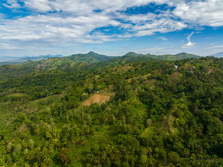 Mountain landscape with rainforest and jungle. Blue sky and clouds. Mindanao, Philippines.