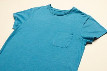 Close up of flat lay of blue t shirt and copy space on yellow background