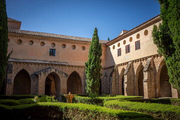 Fototapeta na wymiar Cistercian cloister of the Monasterio de Piedra in Zaragoza, Aragon, Spain with vegetation inside