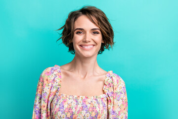 Fototapeta premium Photo of gorgeous pretty satisfied woman with short hairstyle wear colorful dress toothy smiling isolated on turquoise color background