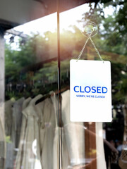Shop closed, white vertical notice sign with words 