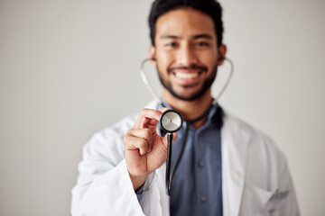 Healthcare, portrait and man doctor hand holding stethoscope in studio for hospital, checkup or...