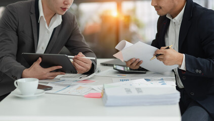 Technology and financial advisory services concert. Business teamwork and working on digital laptop computer with advisor showing plan of investment to clients at table office. Digital marketing.