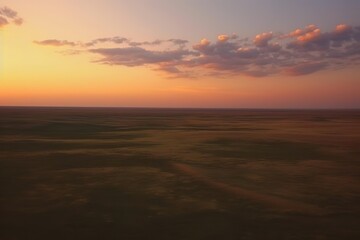 Fototapeta na wymiar Flight over the evening steppe in sunset colors.
