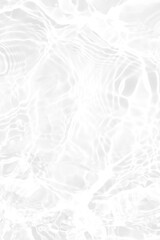 White water with ripples on the surface. Defocus blurred transparent white colored clear calm water surface texture with splashes and bubbles. Water waves with shining pattern texture background.