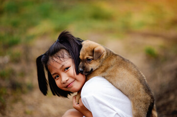Obraz premium little girl and dog Love between man and dog Bonding of children and intelligent pets playing in the backyard love concept