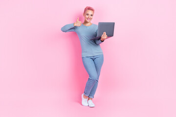 Full length photo of cute confident lady wear blue shirt working modern device rising thumb up isolated pink color background