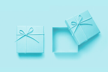 Top view of empty open gift box for congratulations on blue background.