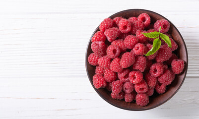 Raspberry in a basket .on wooden background
