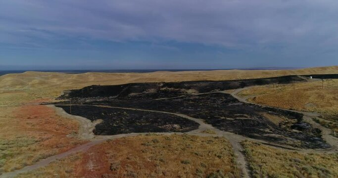 4k drone flyover with pan down of fresh burn scars showing the planes dropped fire retardant. Shot in Central California at 60fps.