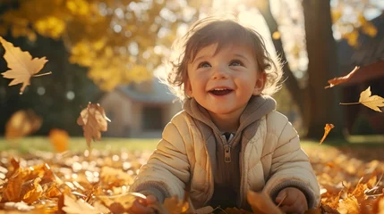 Fotobehang Portrait of young joyful child having fun throwing leaves in autumn. © PhotoGranary