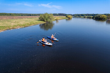 Happy couple man and woman floats on river on supboard. Concept summer lifestyle sport for fun