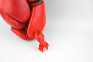 Red ribbon with boxing gloves, wrestling symbol.