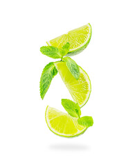 Slices of sour refreshing ripe juicy lime citrus fruit levitating with fresh green mint leaves isolated on white background used as ingredients in cocktails, limeade and lemonades for its flavour