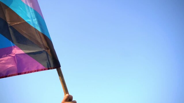 Waving intersex inclusive pride flag template. LGBTQ Progress Pride flag waving in wind at sky. Pride Month events. Tolerance and freedom