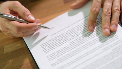 Male buyer signs financial contract concept. .Businessman signs on legal corporate paper