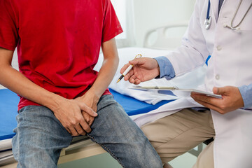 Doctor consulting young man about sexual dysfunction and prostate cancer concept about male health problems