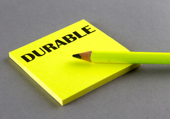 DURABLE text written on a sticky on grey background